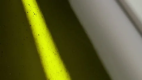 A dark bottle of cider. Bubbles Floating. Macro shot. Stock Footage 147342514