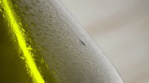 A dark bottle of cider. Macro shot. A drop is rolling down Stock Footage 147342671