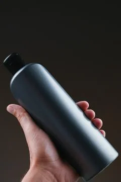 Dark bottle mockup in hands Foto stock