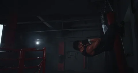 In a dark boxing class cross fit concept athletic young guy doing abs exercises Video stock 117052844