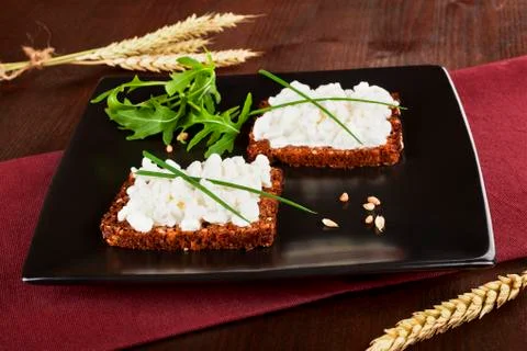 Dark bread with cottage cheese. Stock Photos