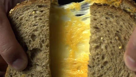 Dark Bread Sandwich with Cheddar Cheese, cooking in slow motion Stock Footage