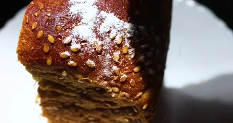 Dark bread for toasts is sprinkled with white powder on top after cooking Stock Footage 251928825
