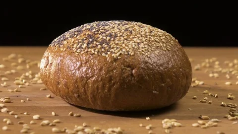 Dark bread turns on the table Video stock 76507296