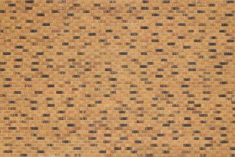Dark brick wall pattern with chaotic masonry order. Background texture or r.. Stock Photos