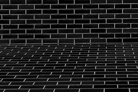 Dark brick wall texture with perspective and shadow Stock Photos