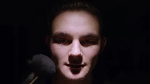Dark brooding overhead lit face getting makeup put on Stock Footage 143068392