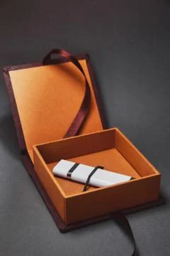 A dark brown box for USB flash drive with a cover made of suede is open with  Stock Photos