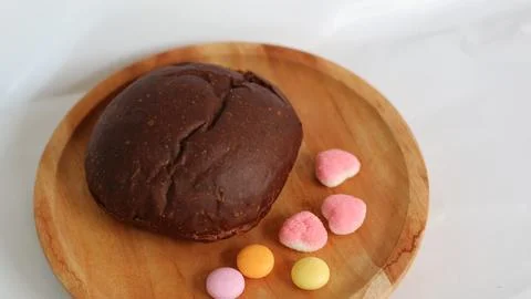 Dark brown bread and six cute candies Stock Photos