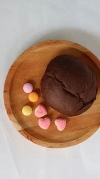 Dark brown bread and six cute candies Stock Photos