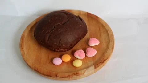 Dark brown bread and six cute candies Stock Photos