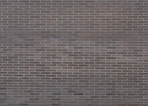 Dark brown bricks dirty wall background with little paint stains Stock Photos
