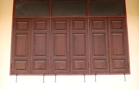 Dark brown doors closed pattern and white wall. Stock Photos
