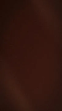 Dark brown grainy texture background with subtle blur for vertical vertical.. Stock Photos