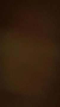 Dark brown grainy vertical background with subtle gold shades abstract text.. Stock Photos