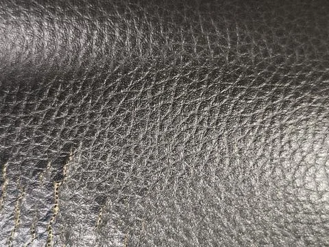 Dark brown leather texture with natural wrinkles and fine grain surface pattern Stock Photos