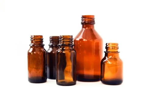 Dark brown phials on white background. Small empty bottles Stock Photos