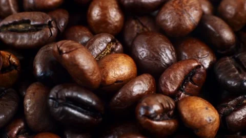 Dark brown roasted coffee beans falling down Stock Footage 229424089