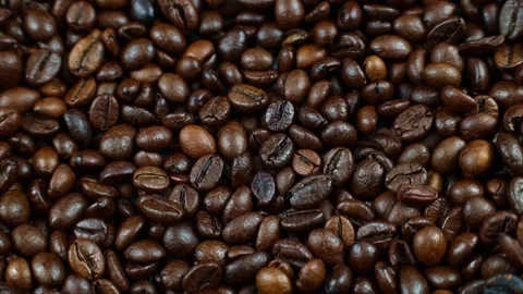 Dark brown roasted coffee beans circle rotation top view Stock Footage 232155277