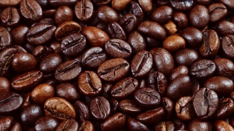 Dark brown roasted coffee beans circle rotation top view Stock Footage 233099413