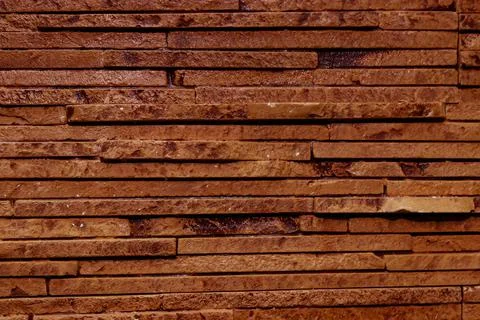 Dark brown texture of a stone wall. Stock Photos
