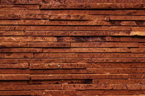 Dark brown texture of a stone wall. Stock Photos
