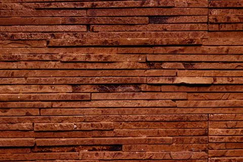 Dark brown texture of a stone wall. Stock Photos