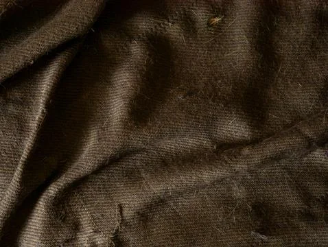 Dark Brown Wool Fabric Texture with Folds and Fibers, Cozy Textile Close-Up.. Stock Photos