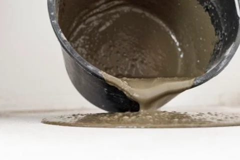 Dark bucket. This is the solution for leveling the floor. on the background o Stock Photos