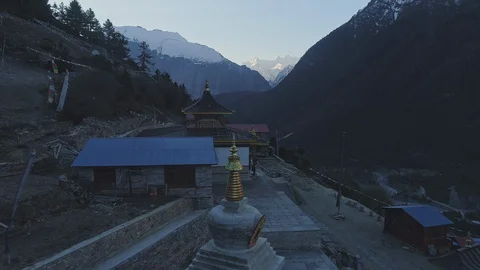 Dark buddhist temple in Upper Pisang at twilight, snowy mountain at horizon Stock Footage 124680128