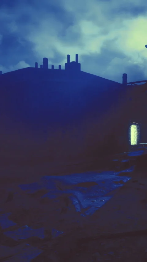 Dark building against cloudy sky with light coming from window Stock Footage 336015236