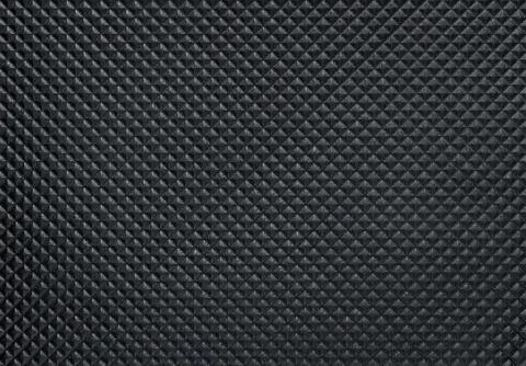 Dark bumpy plastic texture with copy space Stock Photos