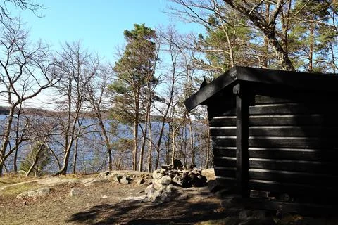 Dark cabin by the lake. Stock Photos