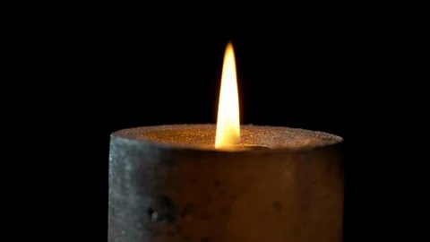Dark candle burning close-up with black background Stock Footage 126061063