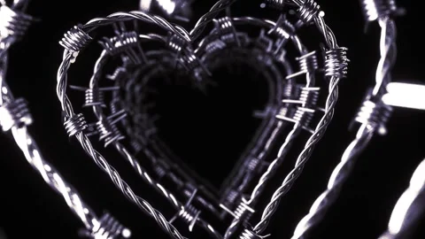 A dark, captivating video of intertwined barbed wire forming a heart shape,  Stock Footage 292051918