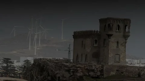 Dark Castle Tower with Eco Windmills in the Background Stock Footage 147981703