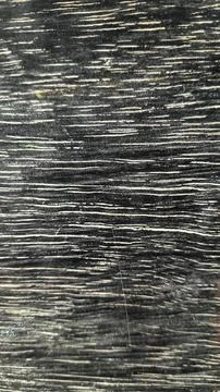 A dark chalkboard marked with white scratch lines, abstract textured background Stock Photos