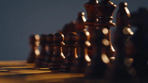 Dark chess figures standing chessboard closeup. Game pieces placed on board Stock Footage 332336850