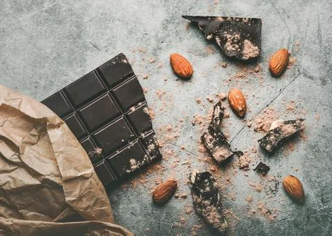 Dark chocolate bar and Broken chocolate pieces and almonds 写真素材