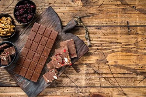 Dark chocolate bar with hazelnuts, peanuts, cranberries and freeze dried Stock Photos