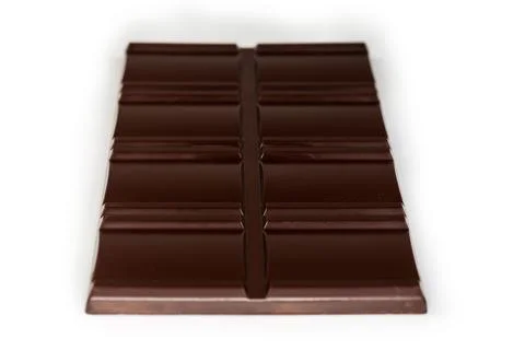 Dark chocolate bar, side view close-up in selective focus Stock Photos