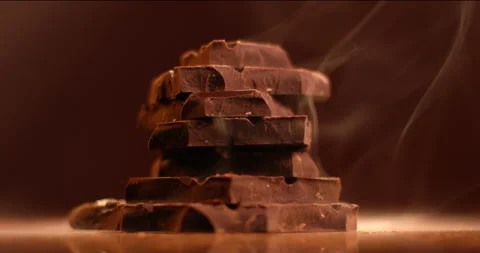 Dark chocolate bars rotating against dark background. Filmed in slow motion with Stock Footage 155343876