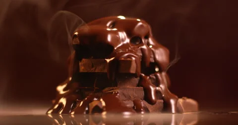 Dark chocolate bars rotating against dark background. Filmed in slow motion with Stock Footage 155392848