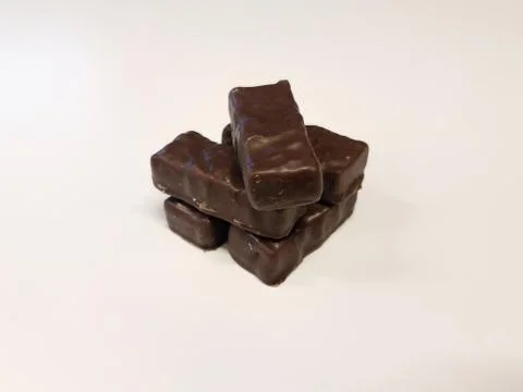 Dark chocolate candy bars on white surface Stock Photos