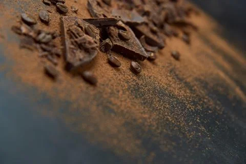 Dark chocolate, chips and cocoa powder with coffee beans on dark background. Stock Photos