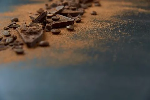 Dark chocolate, chips and cocoa powder with coffee beans on dark background. Stock Photos