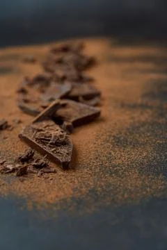 Dark chocolate, chips and cocoa powder with coffee beans on dark background. Stock Photos
