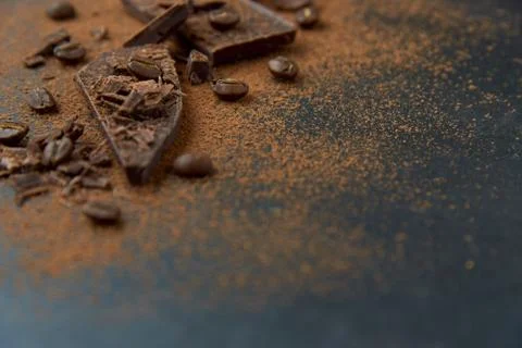Dark chocolate, chips and cocoa powder with coffee beans on dark background. Stock Photos