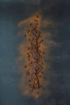 Dark chocolate, chips and cocoa powder with coffee beans on dark background. Stock Photos