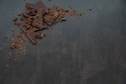 Dark chocolate, chips on a dark background. Confectionery and food concept. Stock Photos